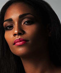 African American wearing Brazilian Carnaval lipstick by Plum & York