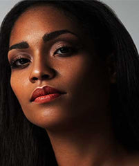 African American wearing LA Isla Naranja lipstick by Plum & York