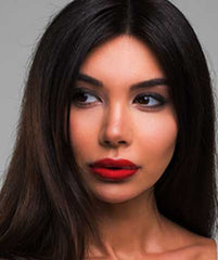 Latina woman wearing Argentine Red Tango lipstick by Plum & York