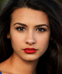 Latina wearing African Safari Sun lipstick by Plum & York, red lipstick for olive skin