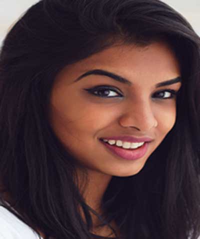 Indian woman wearing Miami Sunset Breeze lipstick by Plum & York