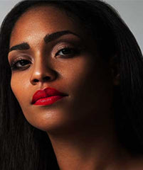 African American woman wearing Argentine Red Tango lipstick by Plum & York, red lipstick for black skin