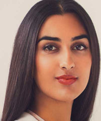 Indian woman wearing LA Isla Naranja lipstick by Plum & York, makeup for brown skin
